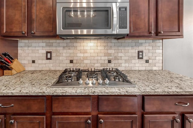 40 Burnside Ct, Frontier Township, MO 63303 - kitchen with stainless steel appliances, tasteful backsplash, and light stone counters