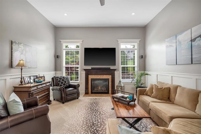 40 Burnside Ct, Frontier Township, MO 63303 - living room featuring a decorative wall, healthy amount of natural light, a premium fireplace, wainscoting, and light carpet