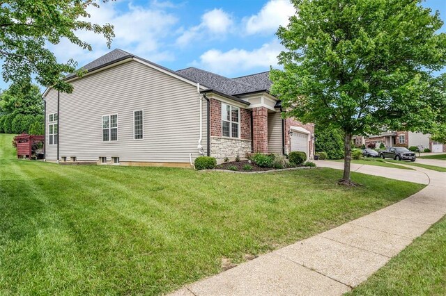 40 Burnside Ct, Frontier Township, MO 63303 - view of home's exterior with concrete driveway, a yard, an attached garage, and roof with shingles