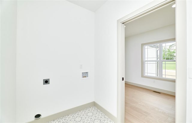 laundry room with washer hookup, electric dryer hookup, baseboards, and light wood-type flooring