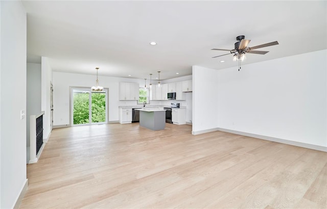 unfurnished living room featuring baseboards, light wood-style flooring, a ceiling fan, recessed lighting, and a fireplace