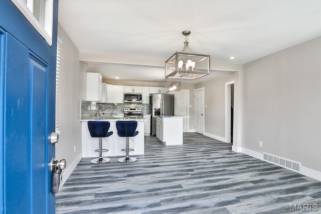 5333 Helen Ave, Jennings, MO 63136 - kitchen featuring stainless steel appliances, baseboards, dark wood-style floors, a chandelier, and recessed lighting