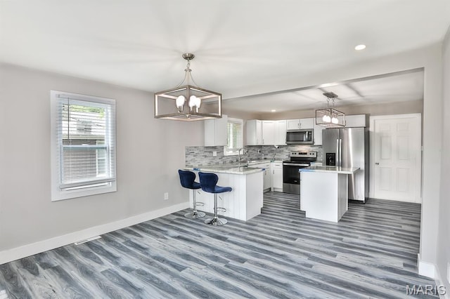 5333 Helen Ave, Jennings, MO 63136 - kitchen featuring stainless steel appliances, a chandelier, plenty of natural light, dark wood-type flooring, and recessed lighting