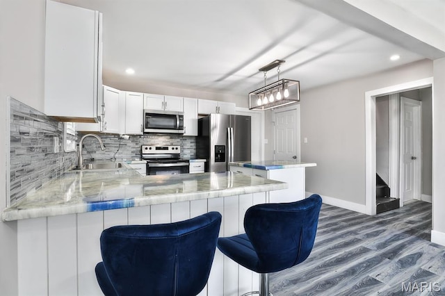 5333 Helen Ave, Jennings, MO 63136 - kitchen with stainless steel appliances, a sink, decorative backsplash, dark wood-type flooring, and baseboards