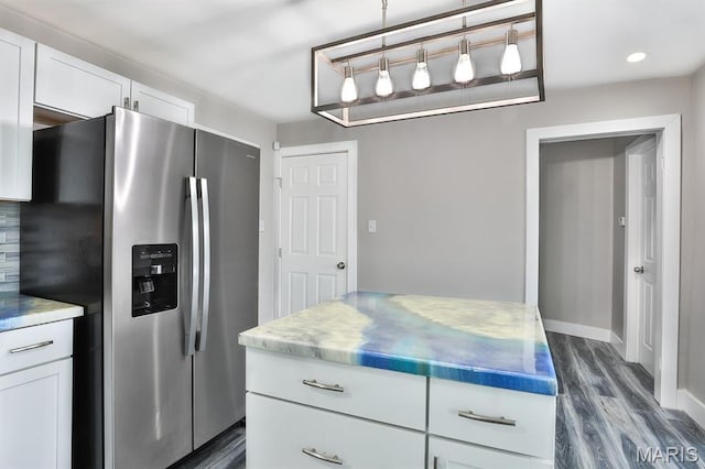 5333 Helen Ave, Jennings, MO 63136 - kitchen with stainless steel refrigerator with ice dispenser, dark wood-style floors, white cabinetry, baseboards, and pendant lighting