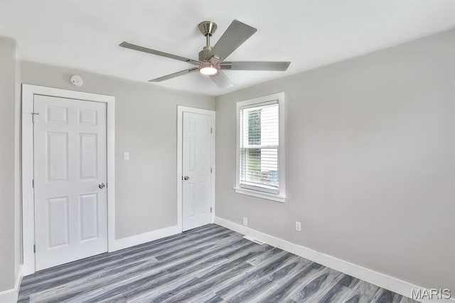 5333 Helen Ave, Jennings, MO 63136 - unfurnished bedroom with wood finished floors, baseboards, and a ceiling fan