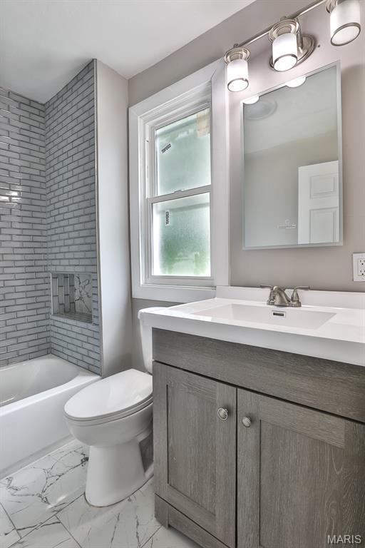 5333 Helen Ave, Jennings, MO 63136 - full bathroom with vanity, toilet, marble finish flooring, and shower / bathtub combination