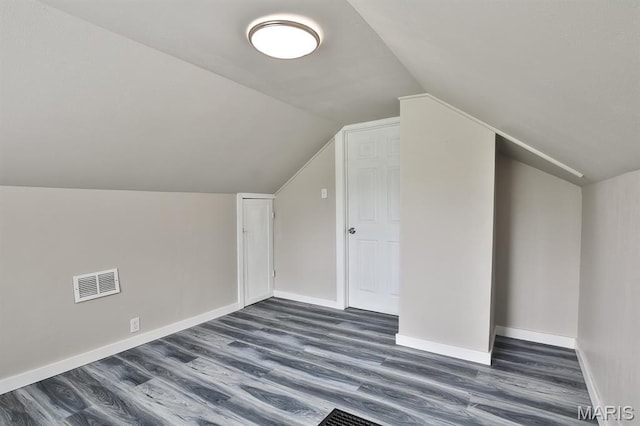 5333 Helen Ave, Jennings, MO 63136 - additional living space featuring dark wood-style floors, lofted ceiling, and baseboards