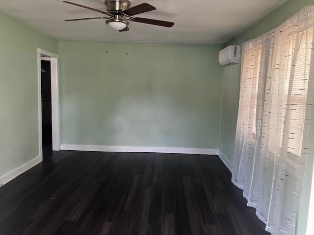 423 W Mckinley Ave, Bernie, MO 63822 - empty room featuring dark wood-style floors, baseboards, an AC wall unit, and ceiling fan