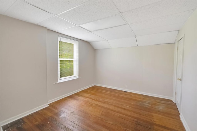 additional living space featuring hardwood / wood-style flooring and baseboards