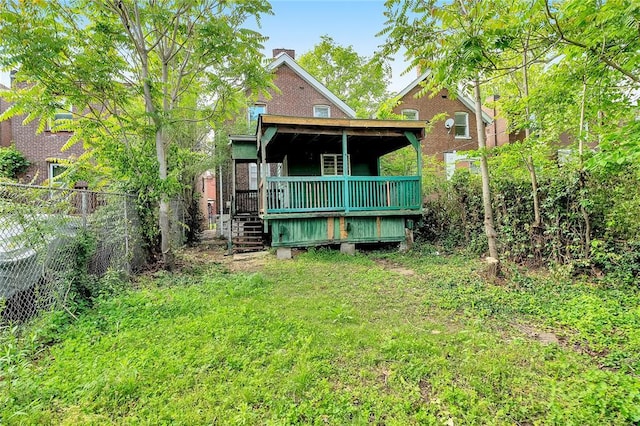 rear view of house with a wooden deck and stairway