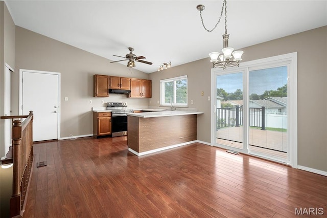 104 Maywood Ct, Saint Peters, MO 63376 - kitchen with electric range, vaulted ceiling, light countertops, dark wood-style floors, and under cabinet range hood