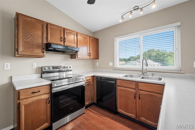 104 Maywood Ct, Saint Peters, MO 63376 - kitchen featuring black dishwasher, stainless steel range with electric cooktop, under cabinet range hood, lofted ceiling, and wood finished floors