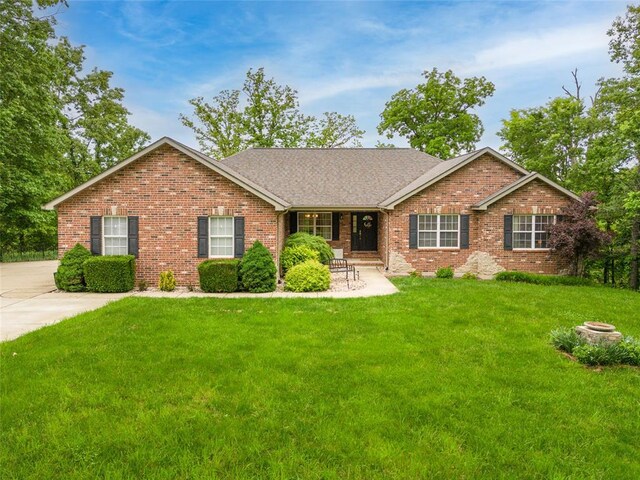 ranch-style house with brick siding and a front yard