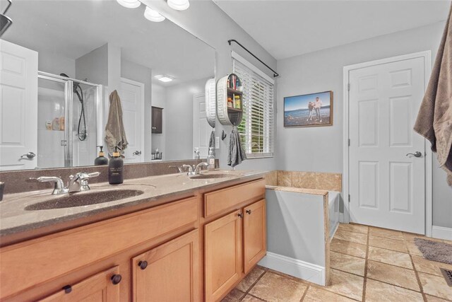 bathroom with a shower stall, double vanity, and a garden tub
