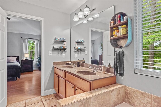 bathroom with connected bathroom and double vanity