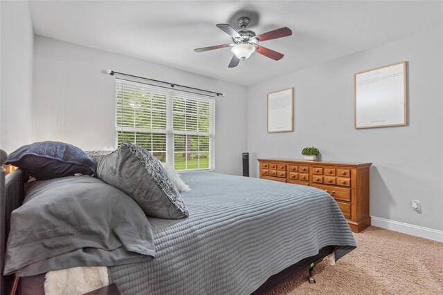 bedroom featuring carpet floors, baseboards, and ceiling fan
