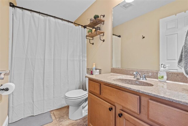 full bathroom featuring toilet, vanity, a shower with shower curtain, and tile patterned floors
