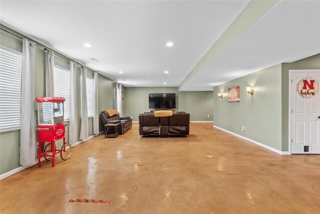 living room with concrete flooring, baseboards, and recessed lighting