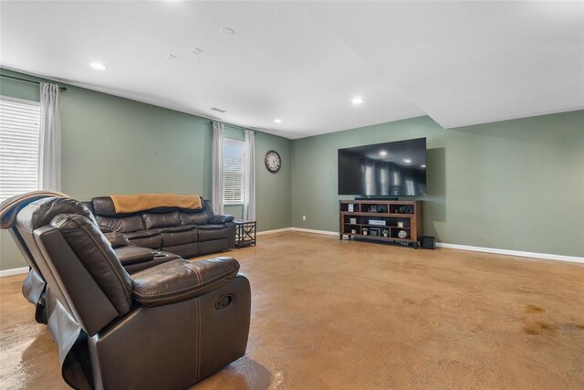 living area with baseboards and recessed lighting