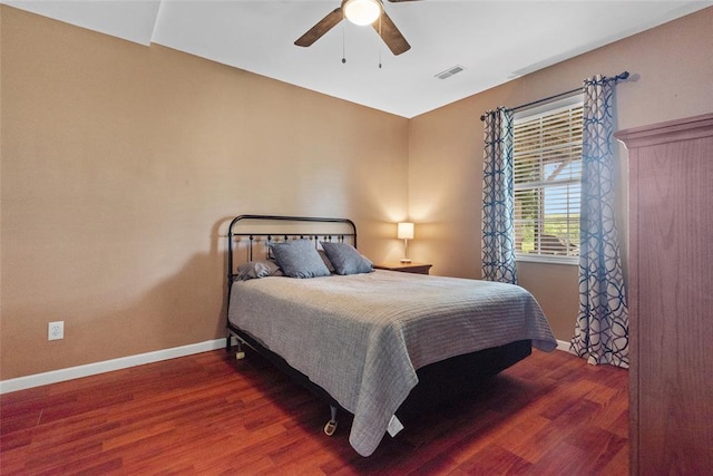 bedroom with wood finished floors, baseboards, and a ceiling fan