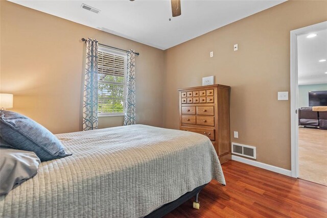 bedroom featuring wood finished floors, baseboards, recessed lighting, and a ceiling fan