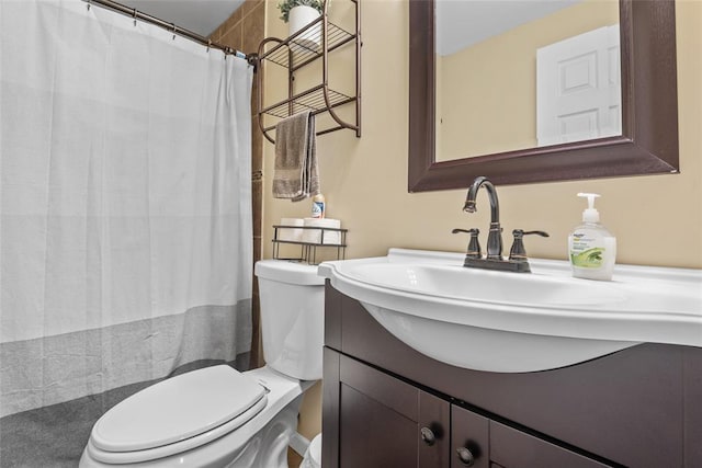 bathroom featuring toilet, vanity, and a shower with shower curtain