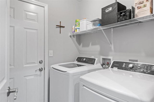 clothes washing area featuring washer and dryer