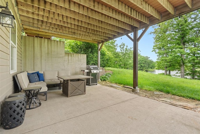 view of patio / terrace featuring grilling area and a water view