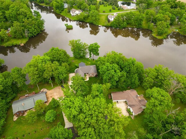 bird's eye view of a nearby body of water and a tree filled landscape