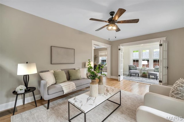 7439 Wellington Ave, University City, MO 63130 - living room featuring a ceiling fan and light wood-style flooring