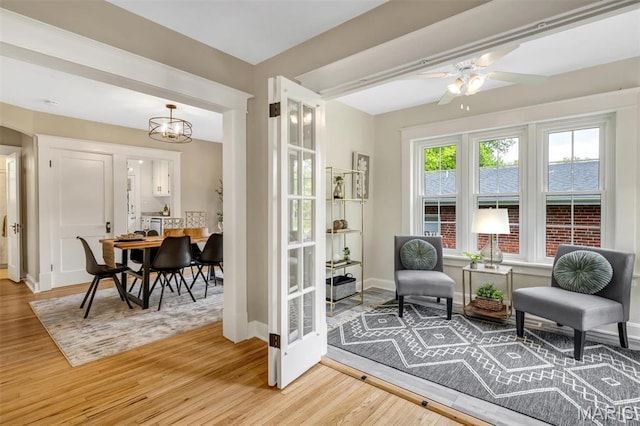 7439 Wellington Ave, University City, MO 63130 - sitting room with light wood-type flooring, a ceiling fan, and a chandelier