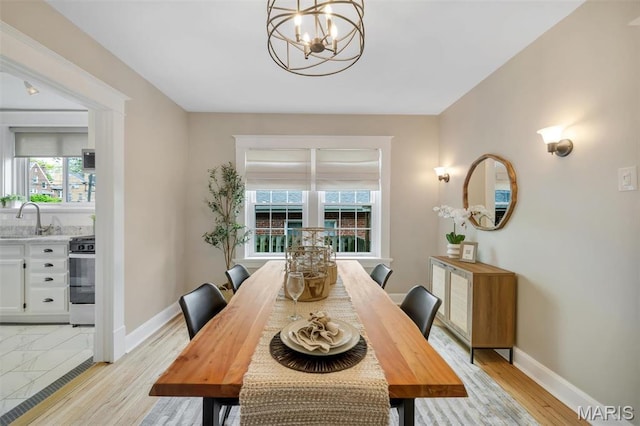 7439 Wellington Ave, University City, MO 63130 - dining space featuring a chandelier and light wood-type flooring