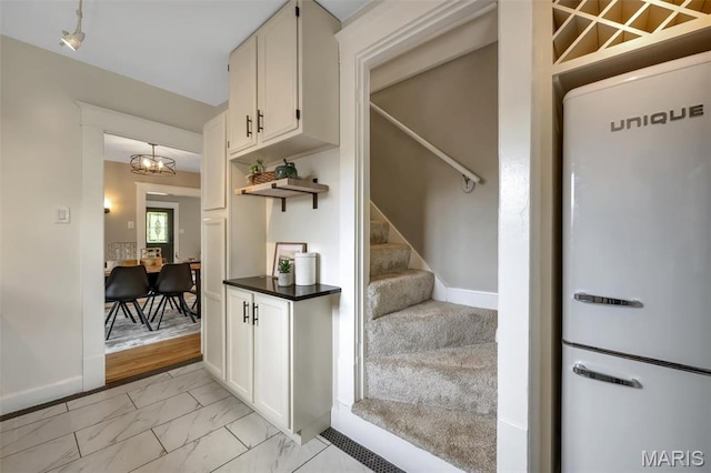 7439 Wellington Ave, University City, MO 63130 - stairs with marble finish flooring and baseboards
