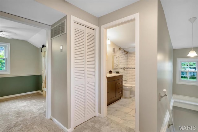 7439 Wellington Ave, University City, MO 63130 - hall with plenty of natural light, lofted ceiling, and light colored carpet