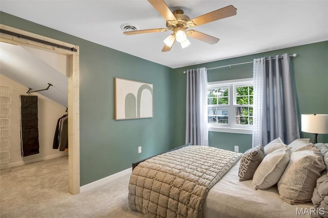 7439 Wellington Ave, University City, MO 63130 - carpeted bedroom featuring ceiling fan and a barn door