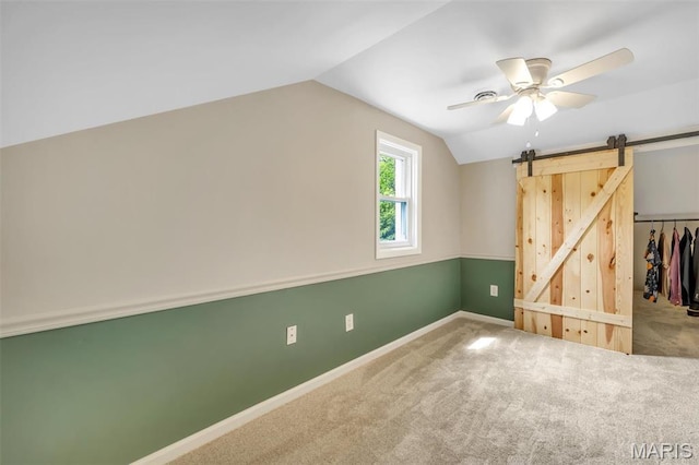7439 Wellington Ave, University City, MO 63130 - additional living space featuring lofted ceiling, carpet flooring, a ceiling fan, and a barn door