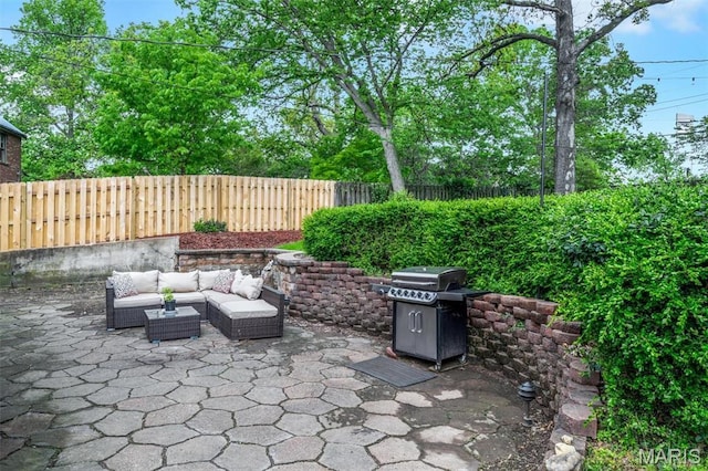 7439 Wellington Ave, University City, MO 63130 - fenced backyard with area for grilling, a patio area, and an outdoor hangout area