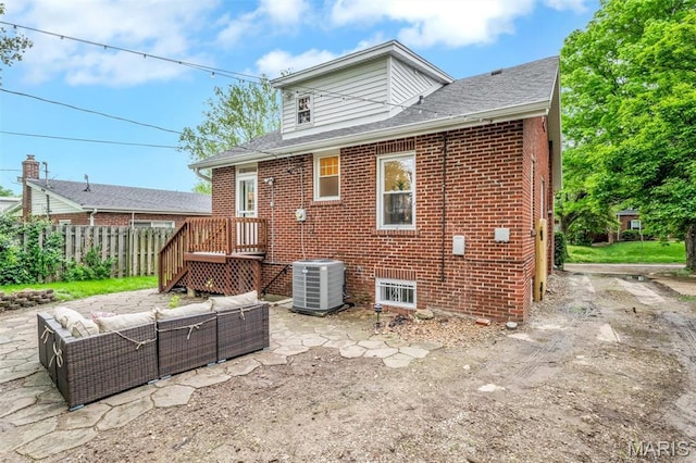 7439 Wellington Ave, University City, MO 63130 - rear view of property featuring an outdoor hangout area, a patio, brick siding, and a shingled roof