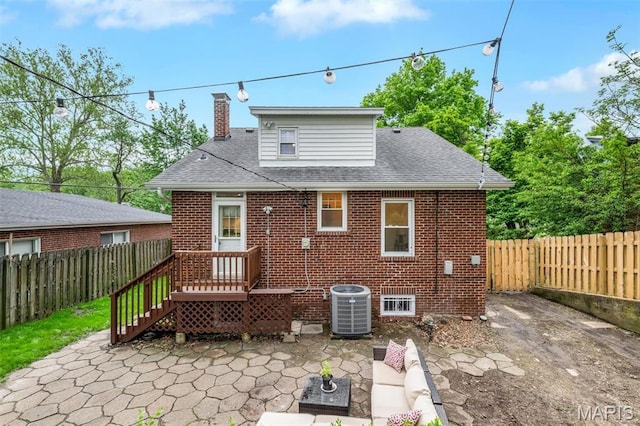 7439 Wellington Ave, University City, MO 63130 - back of house featuring a patio area, a fenced backyard, brick siding, and a shingled roof