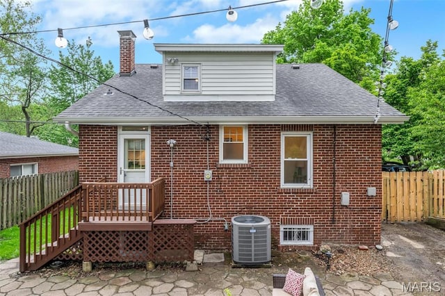 7439 Wellington Ave, University City, MO 63130 - back of house featuring brick siding, a shingled roof, and a chimney
