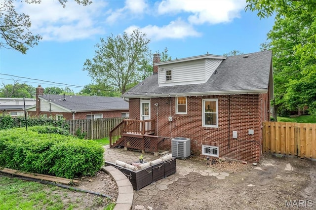 7439 Wellington Ave, University City, MO 63130 - rear view of property with brick siding, a chimney, a shingled roof, and a deck