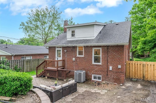 7439 Wellington Ave, University City, MO 63130 - rear view of property featuring a chimney, a fenced backyard, brick siding, a shingled roof, and a patio