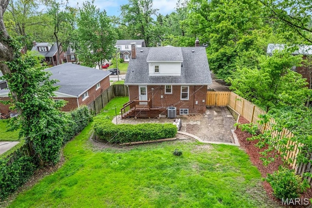 7439 Wellington Ave, University City, MO 63130 - back of property with brick siding, a fenced backyard, and a chimney