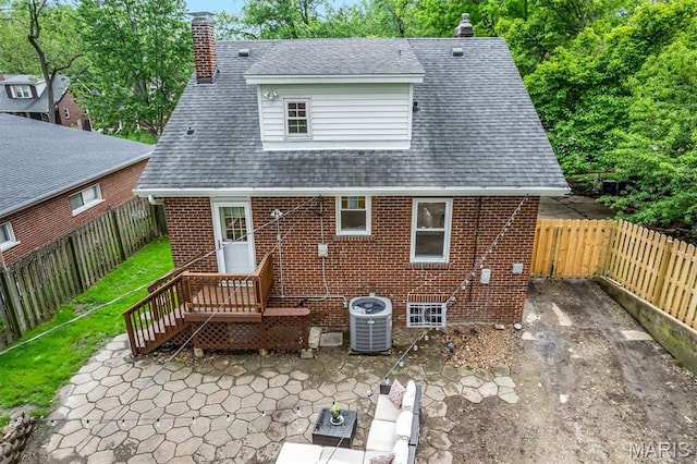7439 Wellington Ave, University City, MO 63130 - rear view of house featuring brick siding, a chimney, a patio, a fenced backyard, and a shingled roof