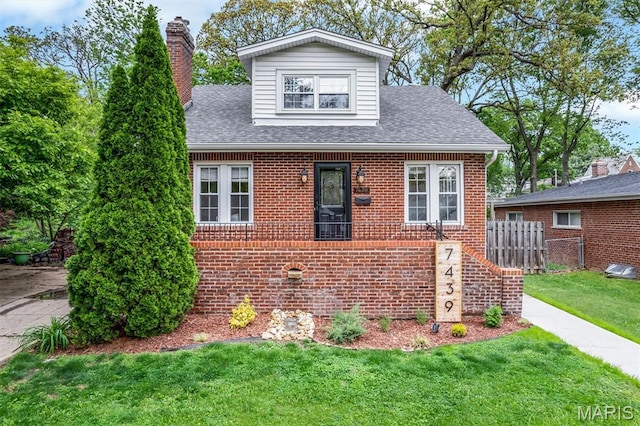 7439 Wellington Ave, University City, MO 63130 - view of front of house with brick siding, a shingled roof, and a chimney