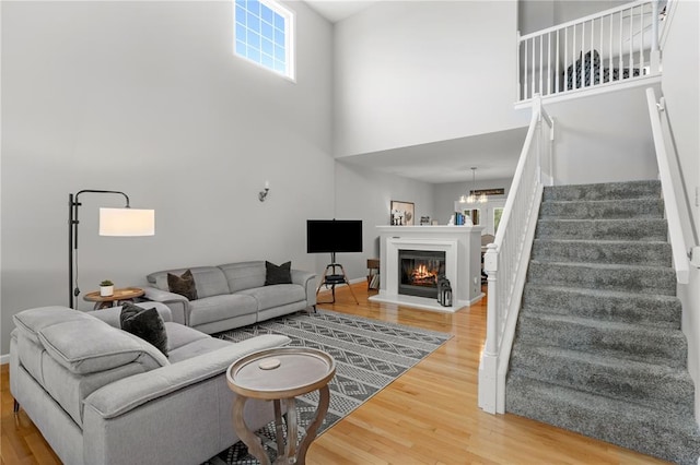 2056 Hawks Landing Dr, Lake St Louis, MO 63367 - living area with a high ceiling, stairway, wood finished floors, and healthy amount of natural light
