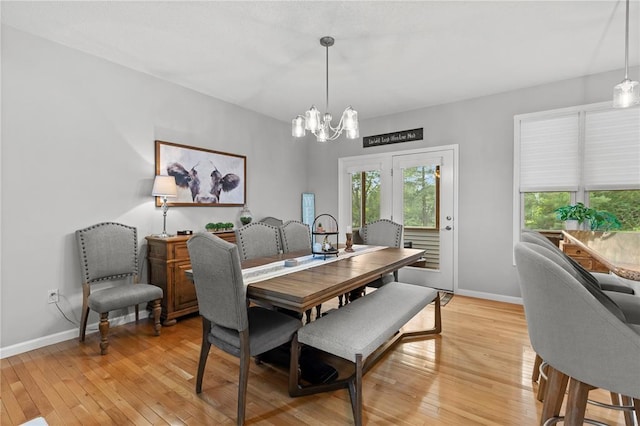 2056 Hawks Landing Dr, Lake St Louis, MO 63367 - dining area with a chandelier, light wood-type flooring, and baseboards
