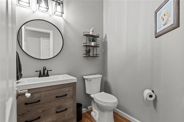 2056 Hawks Landing Dr, Lake St Louis, MO 63367 - bathroom featuring toilet, wood finished floors, vanity, and baseboards