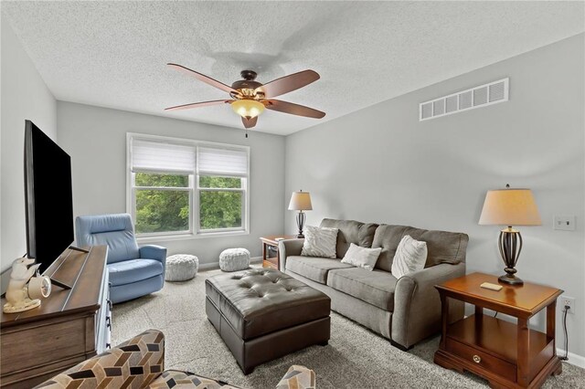 2056 Hawks Landing Dr, Lake St Louis, MO 63367 - carpeted living room with a ceiling fan, baseboards, and a textured ceiling